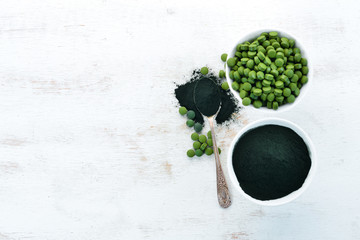 Spirulina powder and tablets. Superfood Top view. Free copy space.