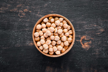 Raw Turkish Pea. Nut. On a black background. Top view. Free copy space.
