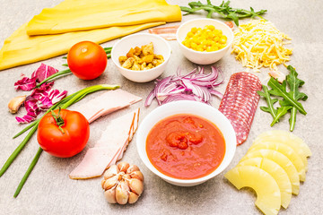 Raw ingredients for pizza, quiche, savory pie. Cooking stone background