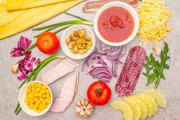 Raw ingredients for pizza, quiche, savory pie. Cooking stone background, top view