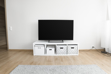Lcd tv on white shef at modern room interior