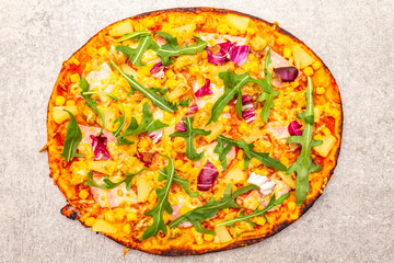 Hot homemade Hawaiian pizza on stone background top view close up.