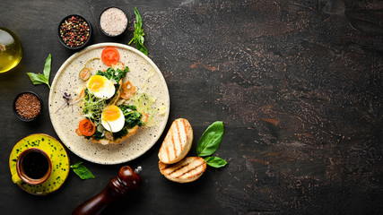 Sandwich with spinach, egg and tomatoes. croissant. Breakfast. In the plate. Top view. Flat lay composition Free copy space.