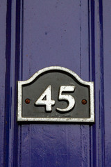 Number 45 seen on a black enamel sign with silver border