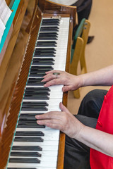 elderly woman playing the old piano