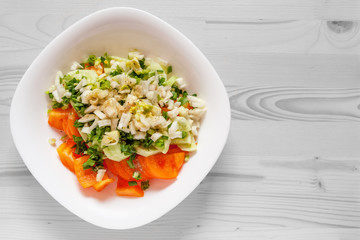 vitamin salad of tomatoes, celery stalks, fennel and green onions seasoned with black pepper and spicy herbs