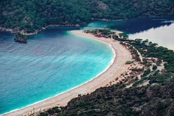Paraglider flying on Oludeniz beach in Fethiye, Mugla, Travel destination. Summer and holiday concept. Lycian way. Panoramic view.