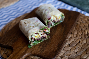 Fototapeta na wymiar Vegetarian Wraps with beetroot, red cabbage, arugula and humus