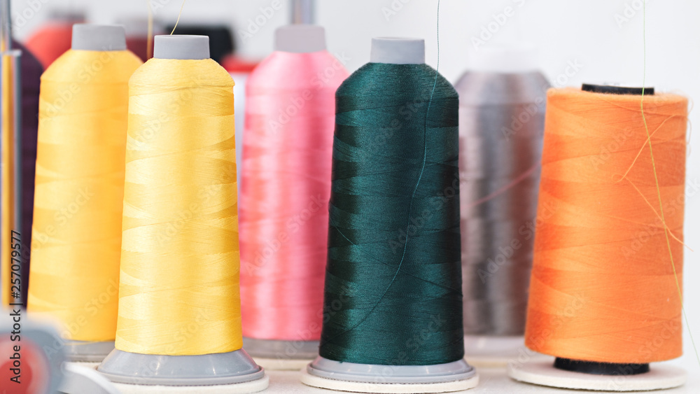 Poster colorful reels of threads. web banner background