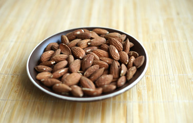Healthy food  for background image close up almond nuts. Texture Nuts on the cup plate