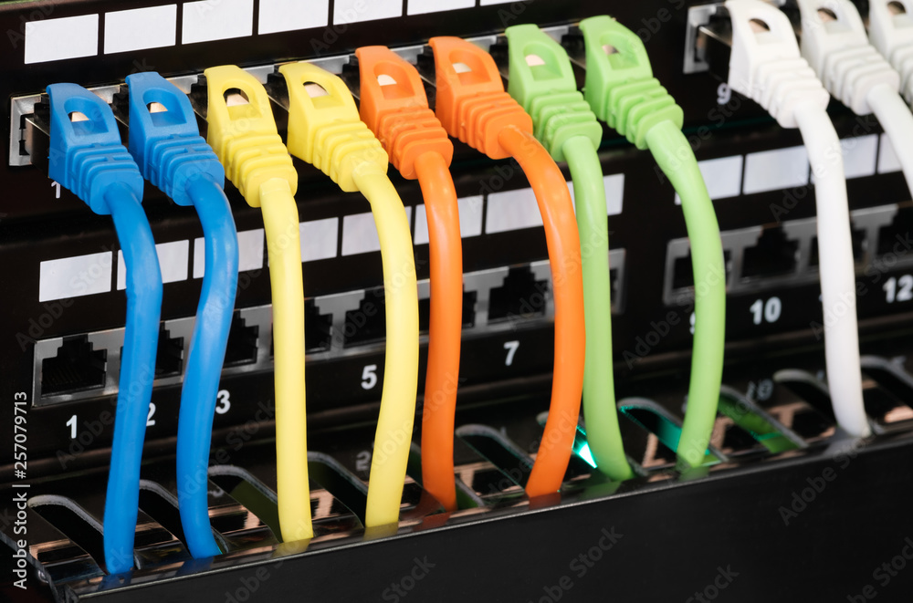 Aufkleber Closeup of  colored computer network cables  connected to a  switch