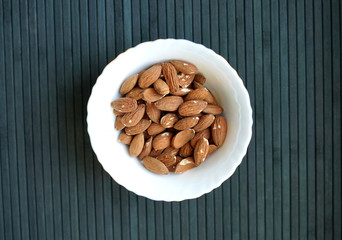 Healthy food  for background image close up almond nuts. Texture Nuts on the cup plate