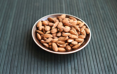 Healthy food  for background image close up almond nuts. Texture Nuts on the cup plate