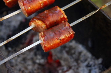 sausage on skewers over coals, barbecue