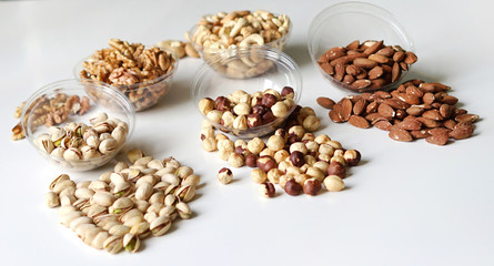Healthy food. Nuts mix assortment on stone table top view. Collection of different legumes for background image close up nuts, pistachios, almond, cashew nuts, peanut, walnut. image