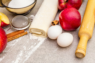 Apple pie ingredients baking concept. Fresh apples with cinnamon, flour, sugar, eggs. Cooking...
