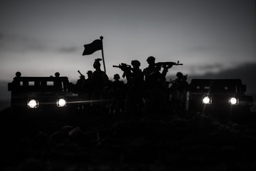 Fototapeta na wymiar War Concept. Military silhouettes fighting scene on war fog sky background, Fighting silhouettes Below Cloudy Skyline At night. Battle scene. Army vehicle with soldiers. army