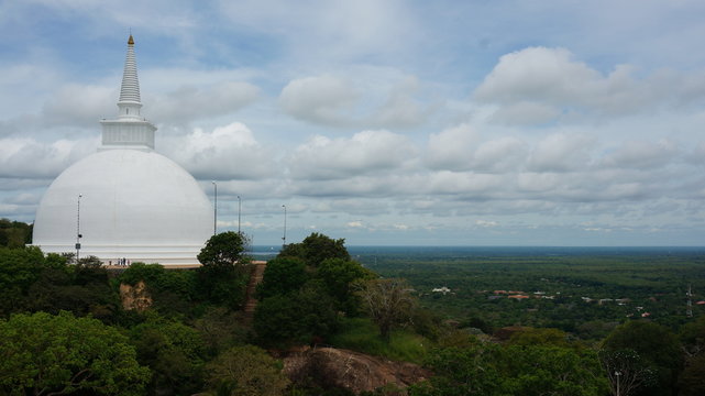 Mihintale, Sri Lanka Big white Buddha statue against blue sky in Mihintale, the cradle of buddhism at Sri Lanka