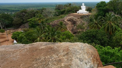 Mihintale, Sri Lanka Big white Buddha statue against blue sky in Mihintale, the cradle of buddhism at Sri Lanka