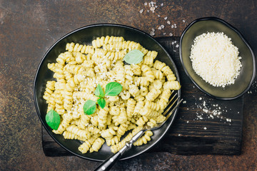 Fusilli pasta with basil, pesto sauce and parmesan cheese