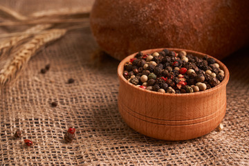 Peppercorns in a wooden bowl on table with food rustic style. Homemade food