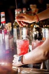 female bartender preparing cocktail in a cocktail bar