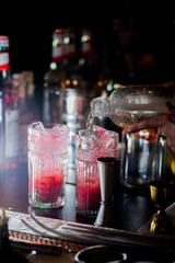 female bartender preparing cocktail in a cocktail bar