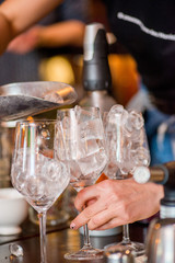 Fototapeta na wymiar female bartender preparing aperol cocktail in a cocktail bar
