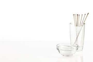 Silver needles for traditional Chinese acupuncture medicine. White background.