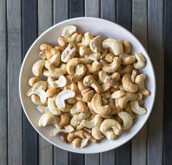 Healthy food  for background image close up cashew nuts.  Nuts texture on top view on the cup plate