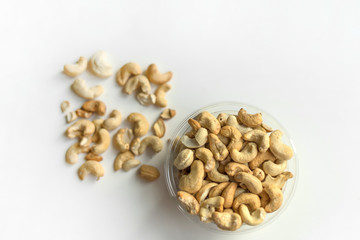 Healthy food  for background image close up cashew nuts.  Nuts texture on white grey table top view on the cup plate