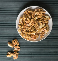 Healthy food  for background image close up walnuts.  Nuts  texture on top view on the cup plate