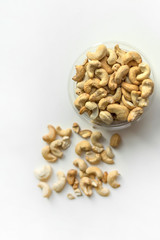 Healthy food  for background image close up cashew nuts.  Nuts texture on white grey table top view on the cup plate