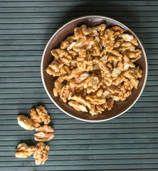 Healthy food  for background image close up walnuts.  Nuts  texture on top view on the cup plate