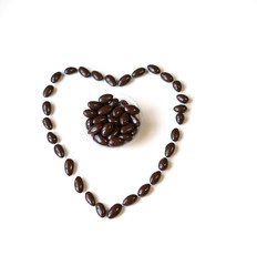 Nuts arranged in heart shape on background. Food image close up candy, chocolate milk, extra dark almond nuts. Love Texture on white grey table top view