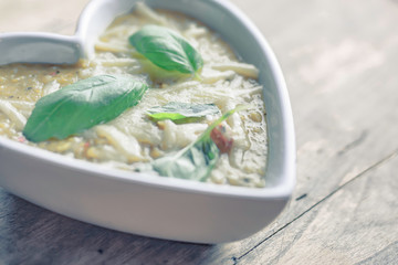 Lentil soup in white heart shaped bowl.