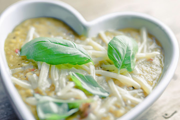 Lentil soup in white heart shaped bowl.