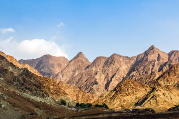 Geological landscape of Jabal Jais characterised by dry and rocky mountains, Road between mud mountains in Ras Al Khaimah, United Arab Emirates
