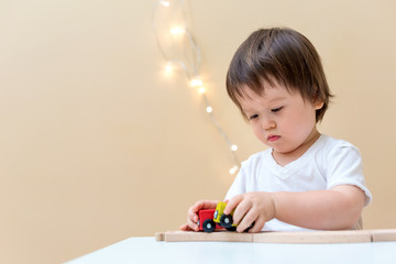 Little toddler boy playing with his toys