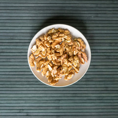 Healthy food  for background image close up walnuts.  Nuts  texture on top view on the cup plate