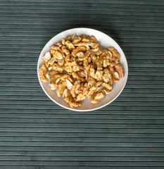Healthy food  for background image close up walnuts.  Nuts  texture on top view on the cup plate