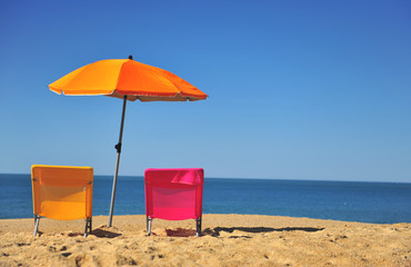 Chairs and umbrella on the beach, summer scene