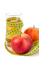 apple and apple juice with tape measure on white background