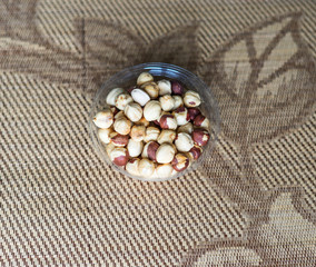 Fototapeta na wymiar Healthy food for background image close up hazelnuts. Nuts texture on top view on the cup plate