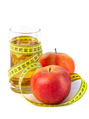 apple and apple juice with tape measure on white background