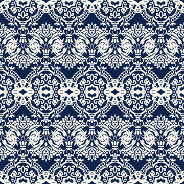 Indigo dye woodblock printed seamless ethnic floral damask pattern. Traditional oriental ornament of India with exotic flowers of Kashmir, ecru on navy blue background. Textile design.