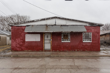 Fototapeta na wymiar Old red brick building left abandoned in depressed urban area