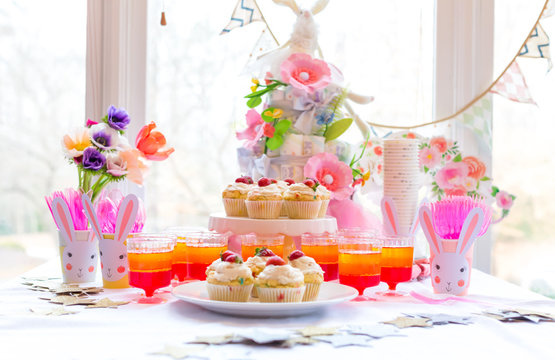 Dessert table with cupcakes and flowers Easter party theme