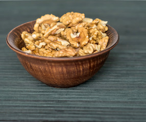 Healthy food  for background image close up walnuts.  Nuts  texture on top view on the cup plate