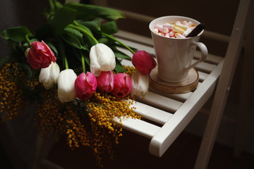March 8,Easter,Mother's day concept /tulips in the vase,cup of coffee with marshmallows